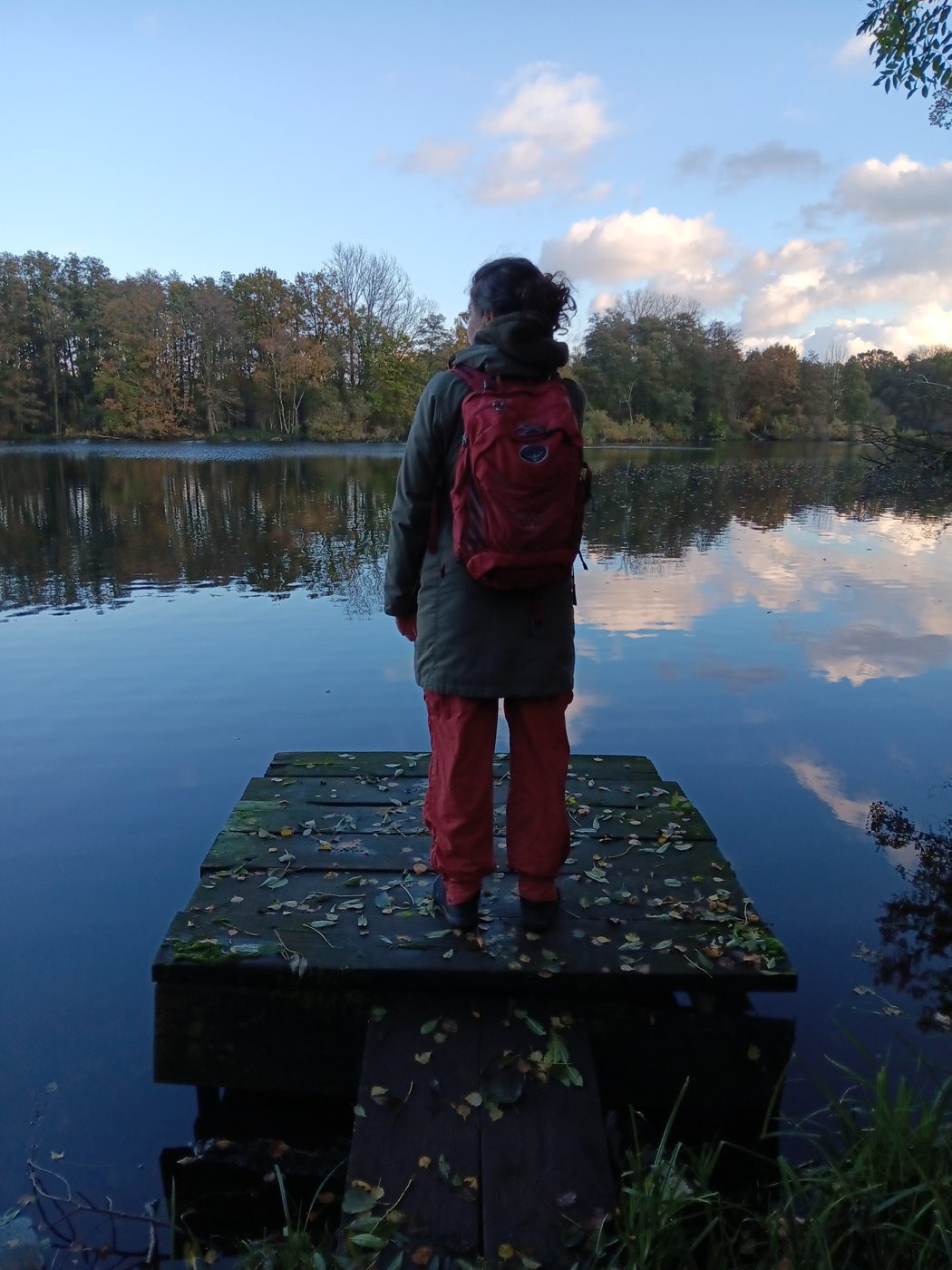Frau am spiegelglatten See im Nettetal – innehalten und wieder in Verbindung kommen